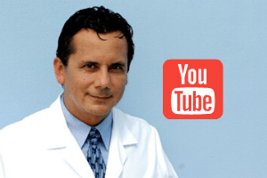 A man in white lab coat and tie next to youtube logo.